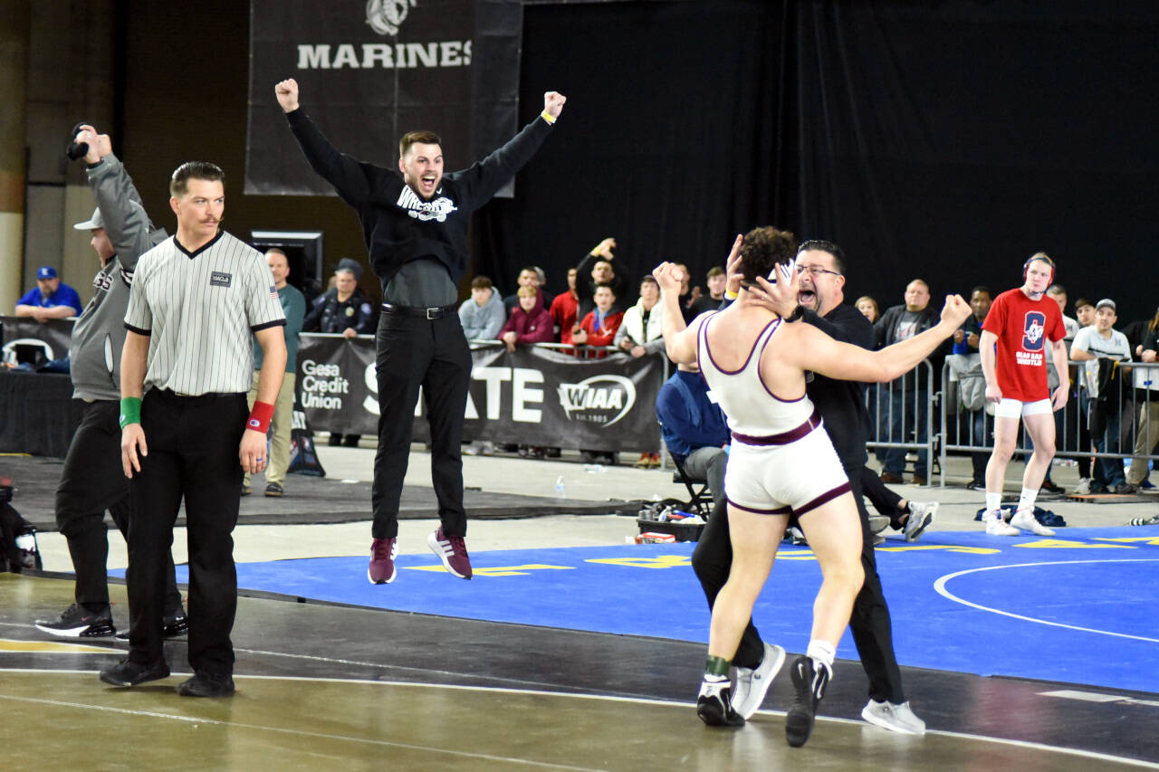 PHOTO BY SUE MICHALAK BUDSBERG Montesano’s Mateo Sanchez, foreground, celebrates with his father Fidel as Montesano assistant coach Tyler Grajek leaps into the air after Mateo won the 1A 182-pound wrestling state championship at the Mat Classic on Saturday in Tacoma.