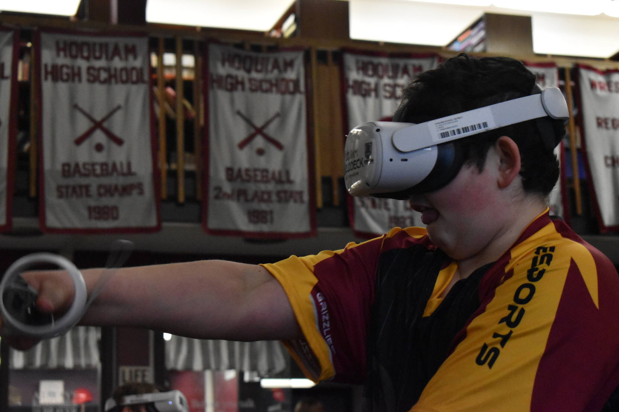 Makai Strum, a member of the Hoquiam Esports middle school team, plays a game of Echo VR, a virtual reality game where players control bodies of robots and attempt to score on opponents in something like a zero-gravity hockey arena. (Clayton Franke / The Daily World)