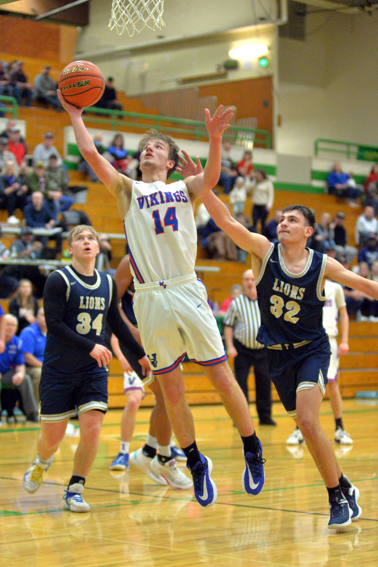 RYAN SPARKS | THE DAILY WORLD Willapa Valley’s Derek Fluke (14) scores two of his team-high 13 points in a 48-34 win over Moses Lake Christian-Covenant Christian in a 1B State first-round playoff game on Saturday in Tumwater.