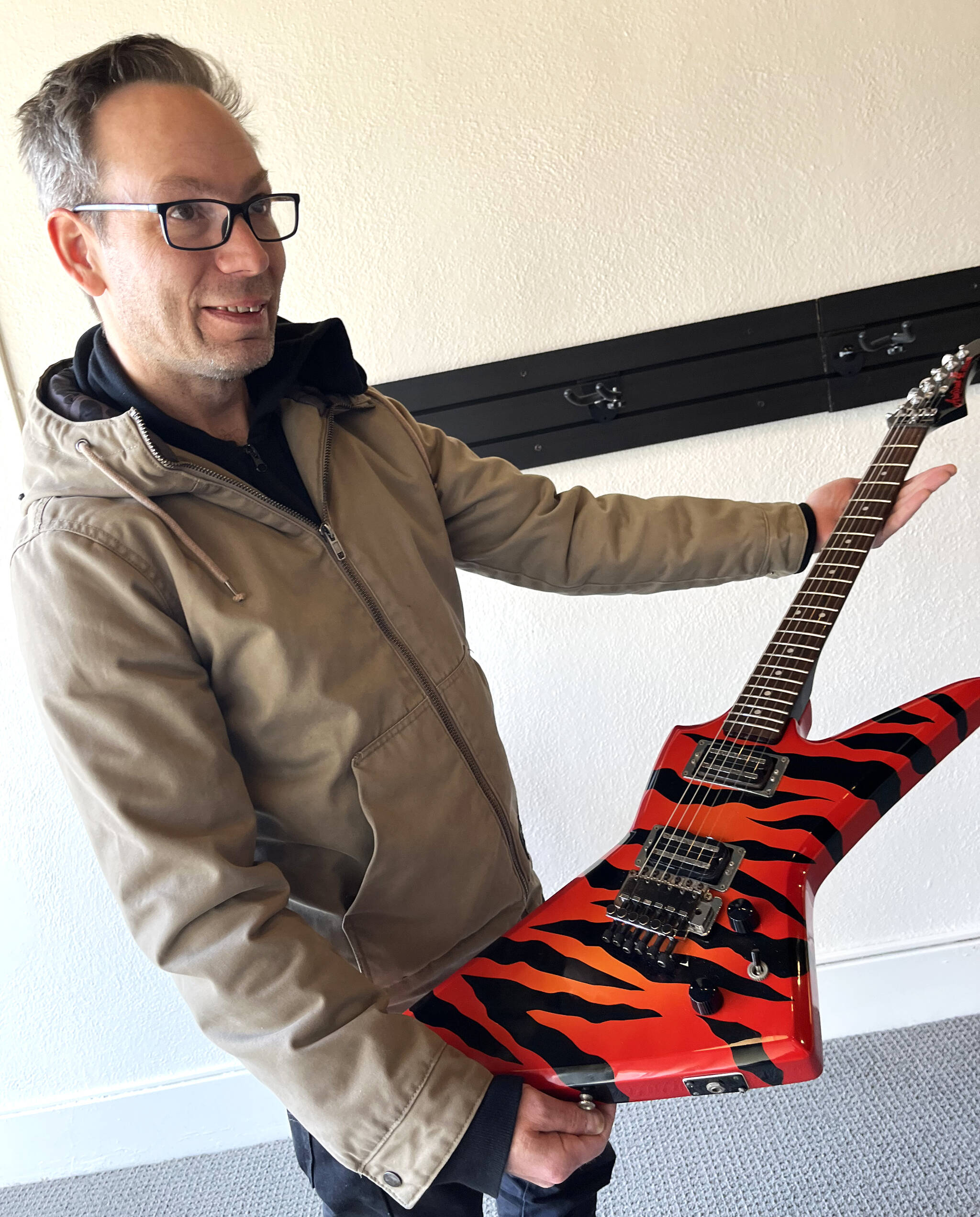 Joe Backus, co-owner of Guitar Galactica, shows off one of the “funky” guitars he’s collected through more than 30 years. This striking tiger-striped Aria Pro II, from Japan, stood out visually on Wednesday when The Daily World spoke to Backus and his business partner Ron Harless. The shop — 204 S. K St., — should open in April. Backus and Harless, who have decades of music store experience in Seattle, can’t wait to get started in downtown Aberdeen.