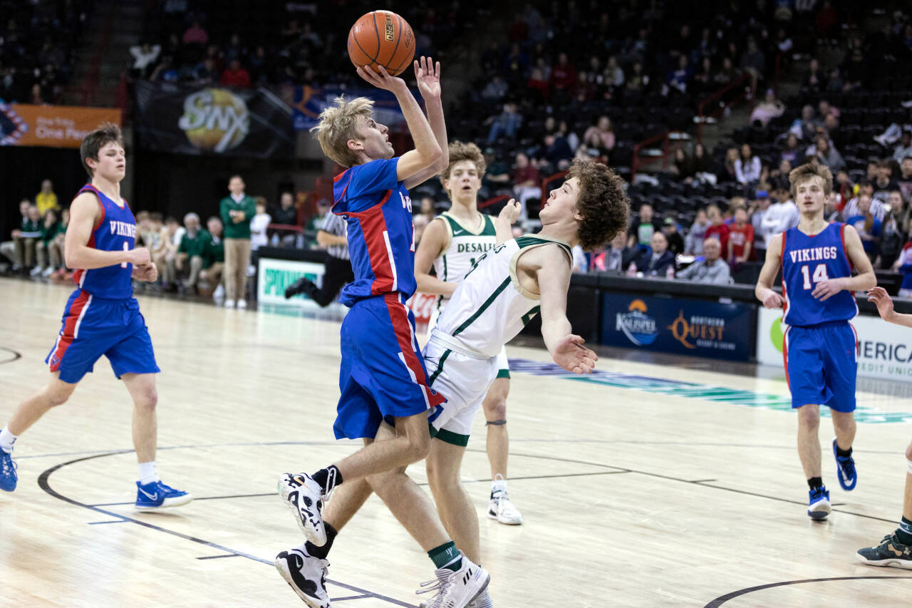 ALEC DIETZ | THE CHRONICLE Willapa Valley guard Riley Pearson, left, is called for a charge against DeSales on Saturday in the 1B 3rd/5th-place game at the Spokane Arena March 4.