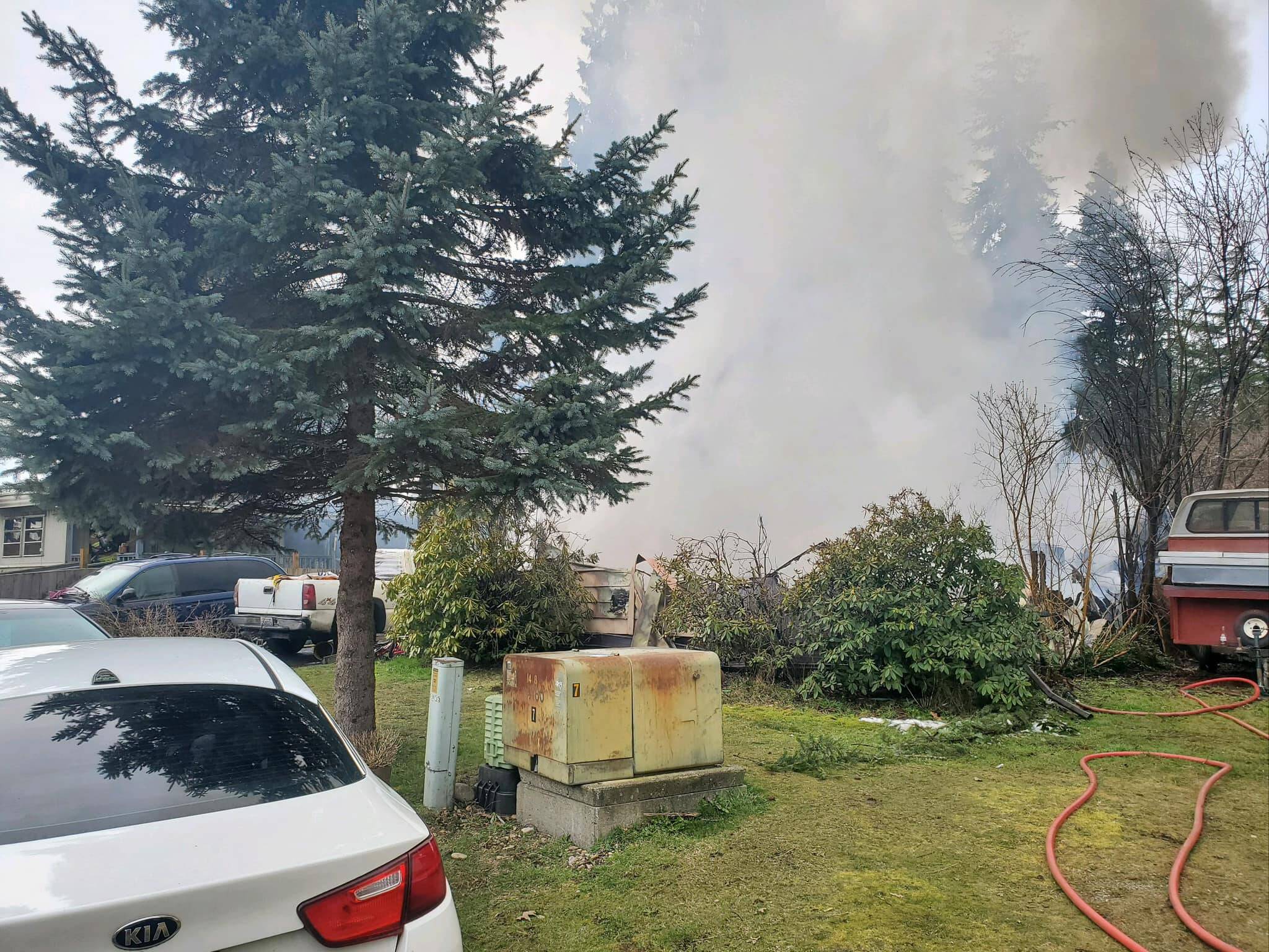 A fire at a residence spread to a tree and destroyed a second residence south of Elma on 25 February. (Courtesy photo / East Grays Harbor Fire and Rescue)