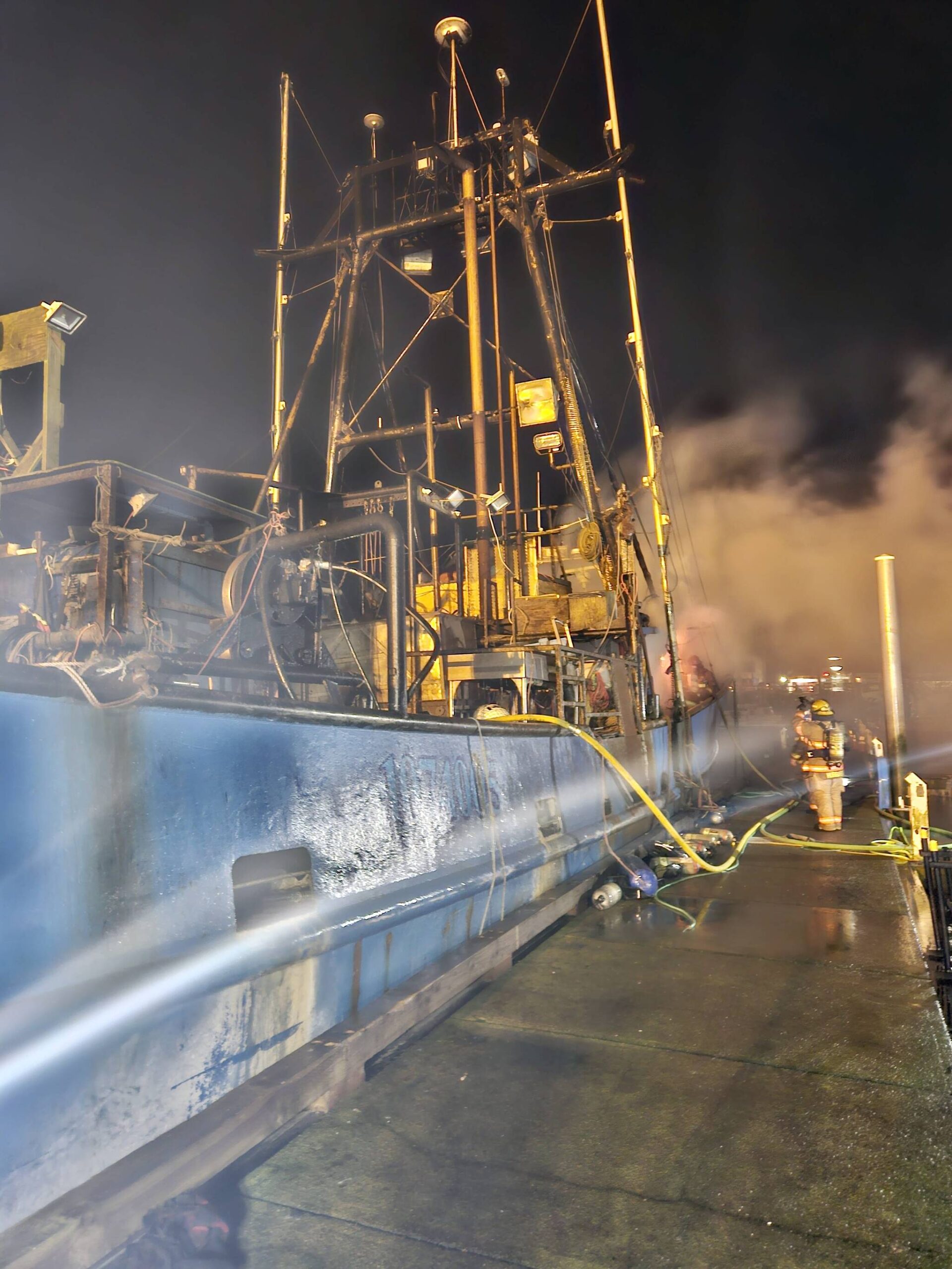 Firefighters from the South Beach Regional Fire Authority combat a blaze aboard a fishing vessel in the Westport Marina on March 9. (Courtesy photo / SBRFA)