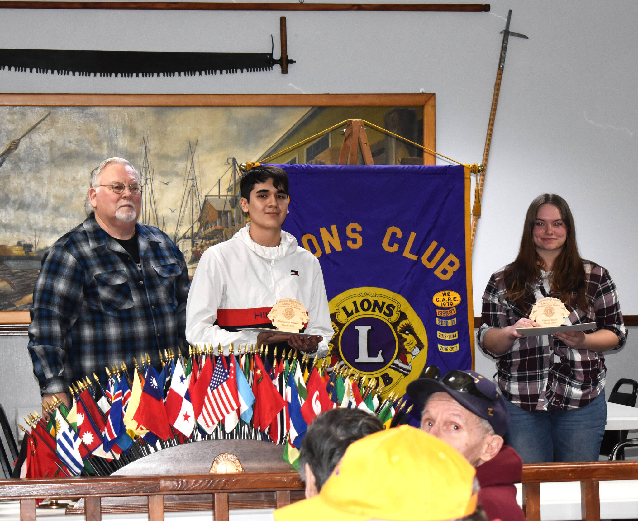 Gerald Schaefer, left, stands with Alejandro Atwell and Carron Blood on Tuesday. The pair of senior Hoquiam High School students received “Student of the Month” awards from Hoquiam Lions Club in front of at least 100 attendees who were inside the Hoquiam Elks Lodge. Both students have at least an eye on attending Grays Harbor College in the future.
Matthew N. Wells
 / The Daily World