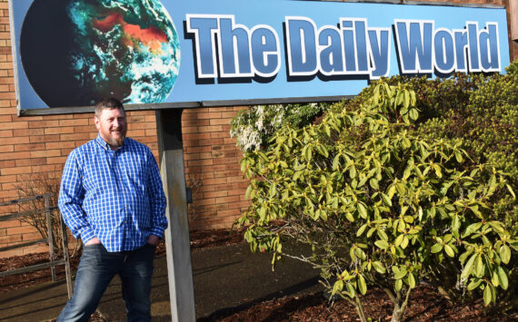Matthew N. Wells / The Daily World
Terry Ward, the publisher for The Daily World, announced Wednesday morning that Doug Ames — pictured — is the newspaper’s new interim general sales manager. Ames stands in front of The Daily World sign that he himself installed a couple months ago.