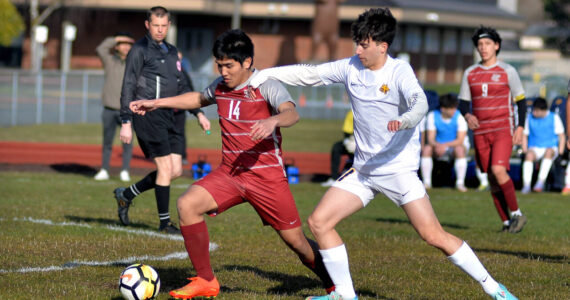 RYAN SPARKS | THE DAILY WORLD 
Hoquiam's Kunanon Chaiyakam (14) and Aberdeen's Giovanni Ambrogiani compete for possession during the Bobcats' 10-0 win on Wednesday at Sea Breeze Oval in Hoquiam.