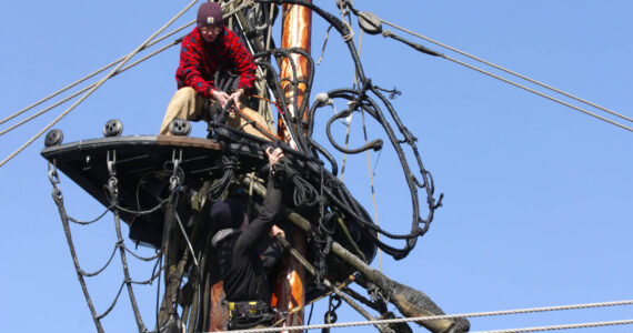 Michael S. Lockett / The Daily World
The crew of the Lady Washington hoist parts of the topmasts aloft as they prepare the ship for sea.