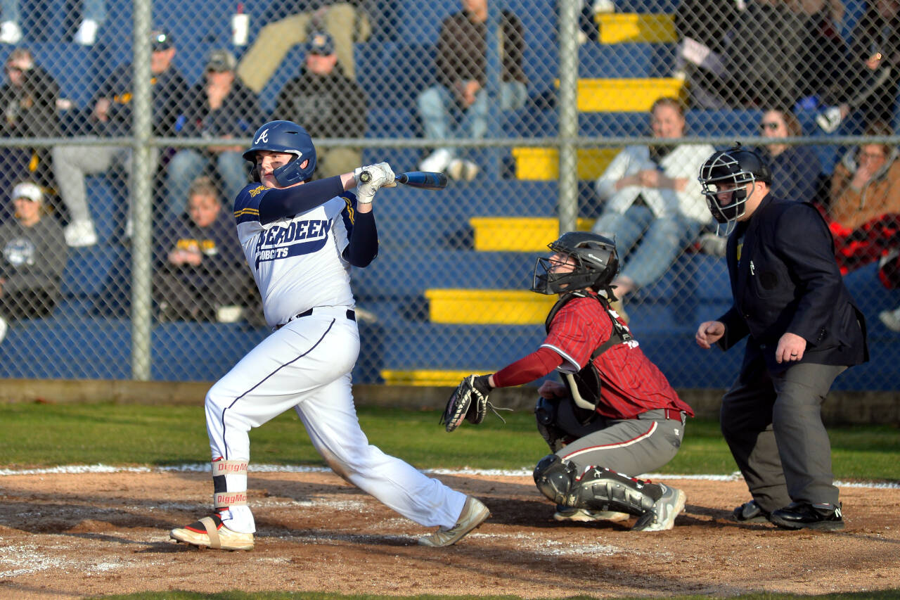 RYAN SPARKS | THE DAILY WORLD Aberdeen’s Trevon Nichols smacks a base hit during the Cats’ 10-0 victory over Hoquiam in the season-opener on Thursday at Pioneer Park in Aberdeen.