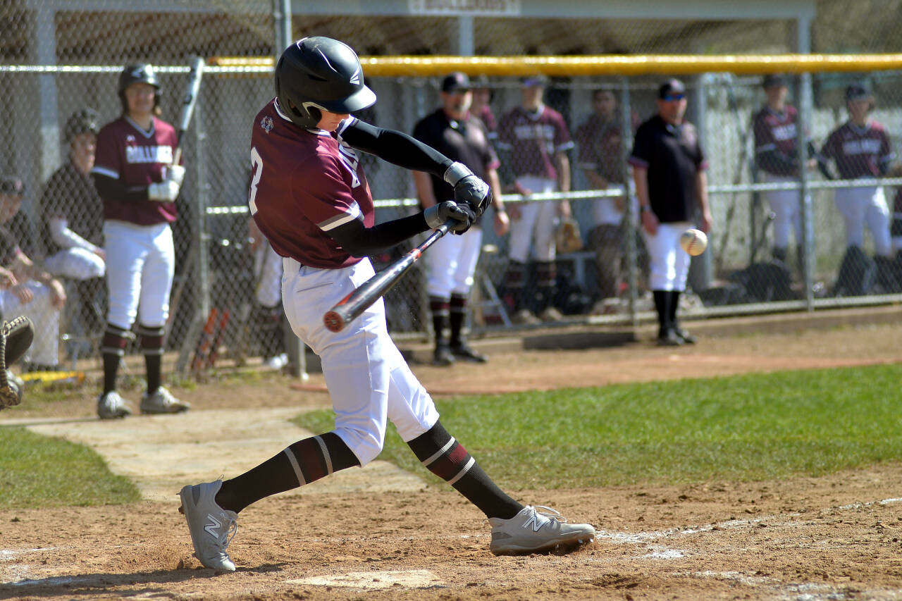 RYAN SPARKS | THE DAILY WORLD Montesano’s Josh Wills drives in a run with a base hit during the Bulldogs’ 6-3 victory against Overlake on Saturday at Vessey Field in Montesano.