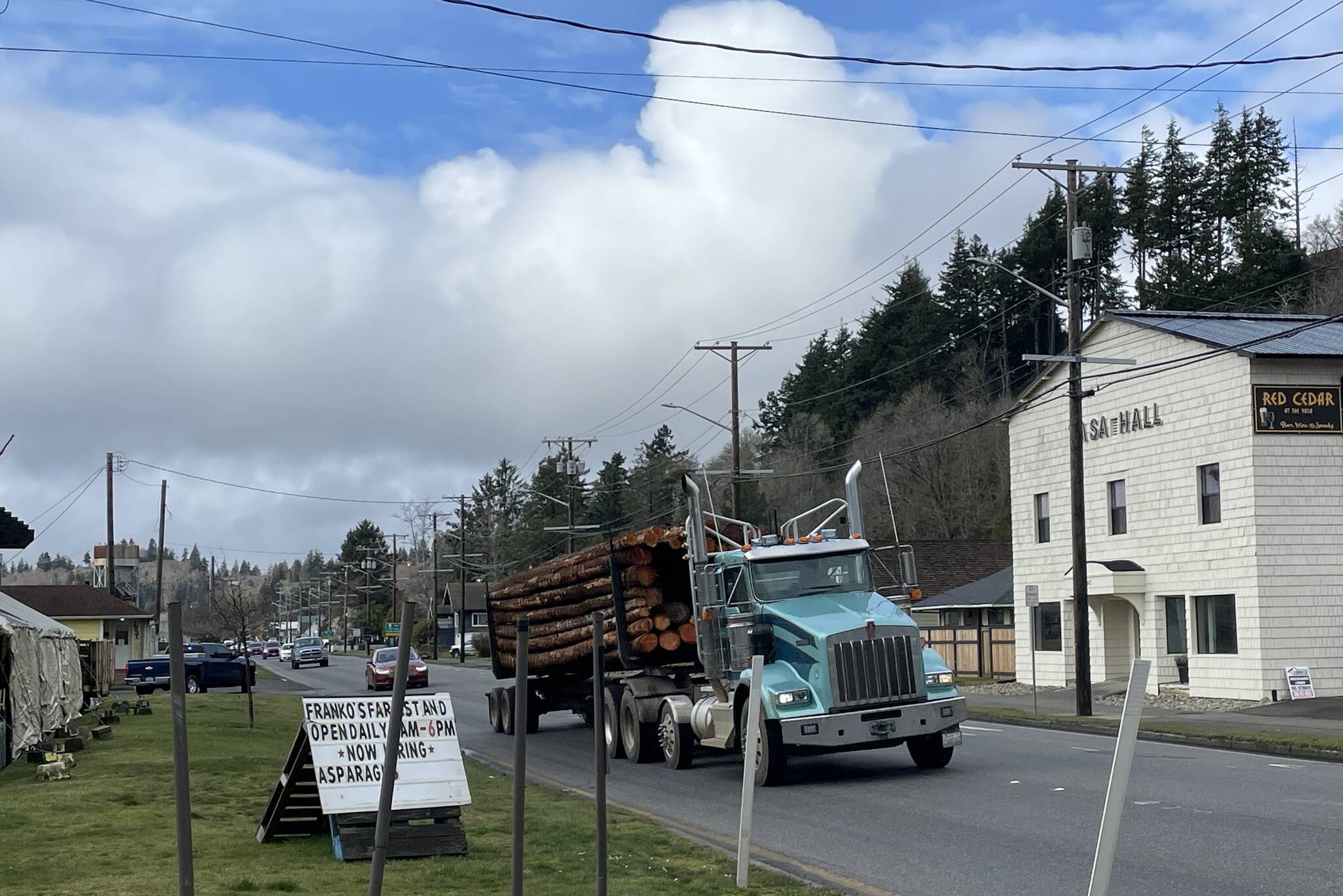 Michael S. Lockett / The Daily World 
A log truck makes its way down Riverside Avenue as Hoquiam Police Department and Public Works Department personnel directed alternating flows of traffic to ease pressure from a bridge malfunction.