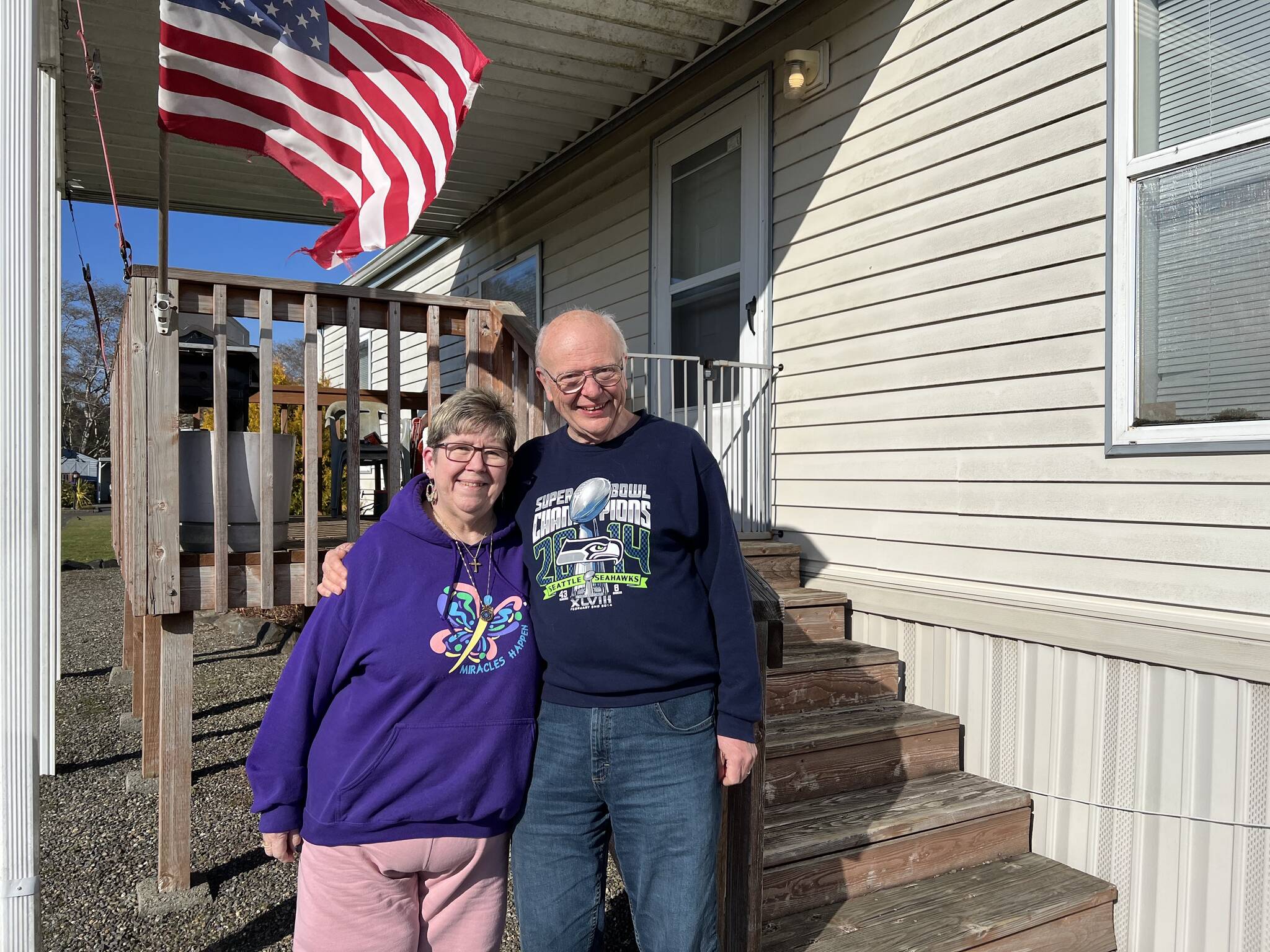 Caroline (left) and Bill Hardy pose outside their mobile home in South Aberdeen. (Clayton Franke / The Daily World)