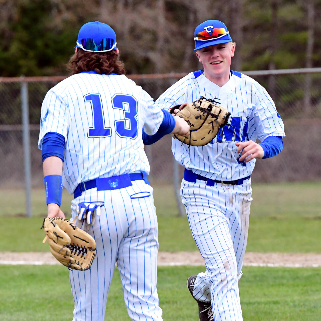 PHOTO BY CHRYSTAL WELD Elma’s Grant Vessey, right, and Gibson Cain high-five during the Eagles’ double header sweep over Hoquiam on Wednesday in Elma.
