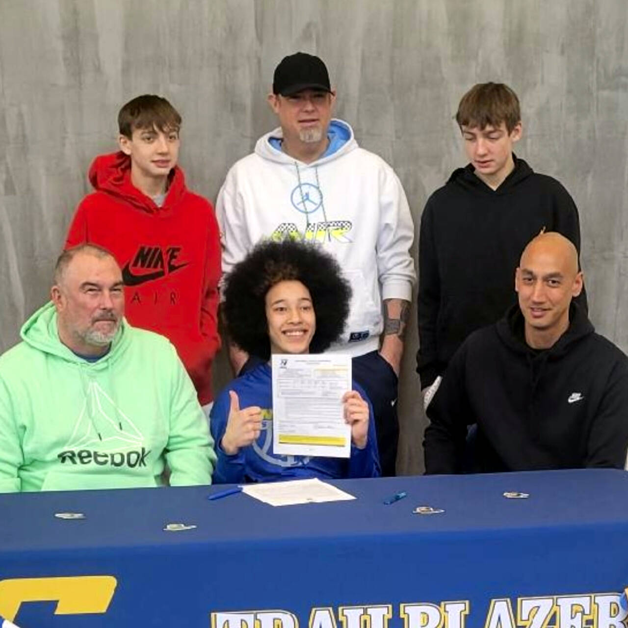 SUBMITTED PHOTO Aberdeen senior guard Maddie Gore (front row, middle) gives a thumbs up after signing a Letter of Intent to compete for Centralia College on Saturday in Centralia. Pictured are (front row, from left) Robert Gore, Maddie Gore, Jimmy McDaniel, (back row, from left) Talon Morrill, Brian Morill and Quinton Morrill.
