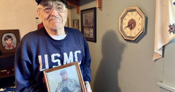 Michael S. Lockett / The Daily World
Jim Evans, one of the Chosin Few, poses in his residence with a picture of Marine Corps legend “Chesty” Puller.