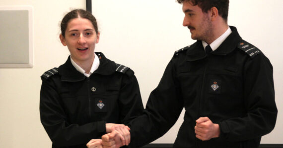 Michael S. Lockett / The Daily World
Officer Niamh Donnelly, left, and Officer Daniel Clemson, of His Majesty’s Prison and Probation Service, demonstrate a hold to an international group of corrections personnel at Stafford Creek Corrections Center on April 17 as part of an effort to bring a more human-rights focused approach to corrections.