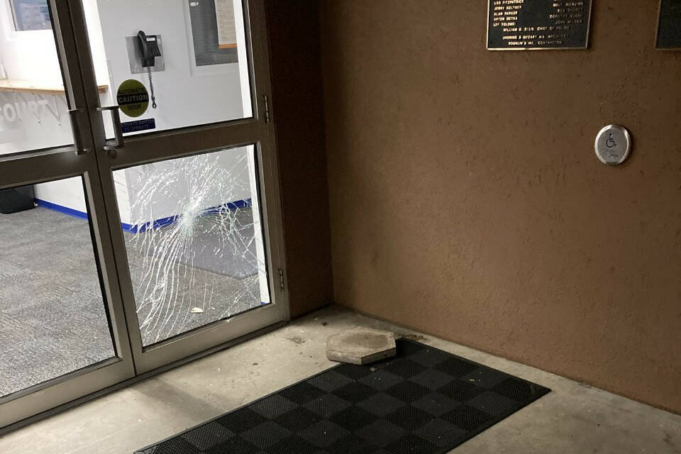 A stepping stone used to break the window of the Aberdeen Police Department’s sliding door is visible on the ground after the incident. (Courtesy photo / APD)