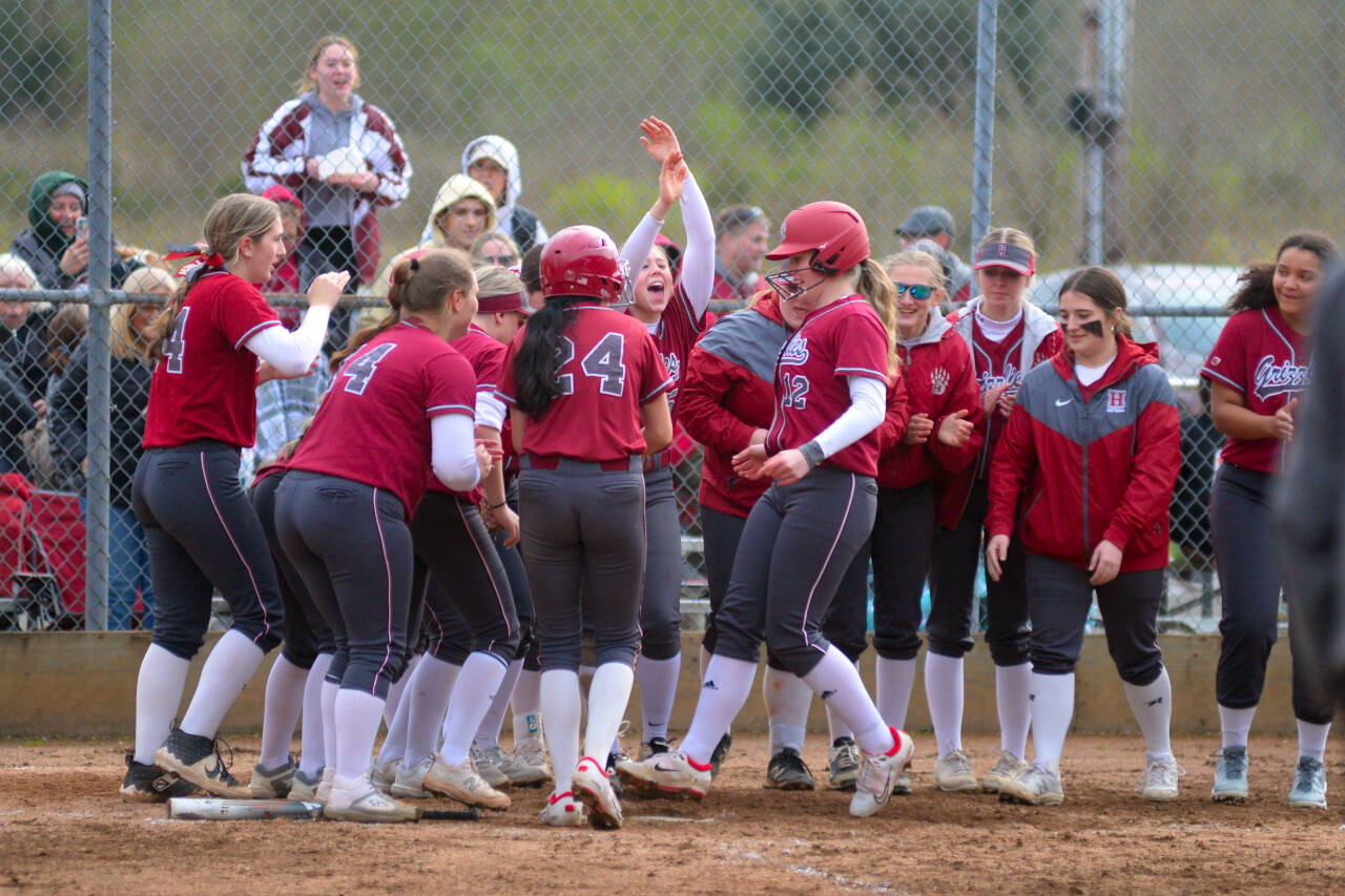 RYAN SPARKS | THE DAILY WORLD Hoquiam’s Ashlinn Cady (12) is greeted by her teammates after hitting a two-run home run in the bottom of the sixth inning during a 7-6 win over Montesano on Friday in Hoquiam.