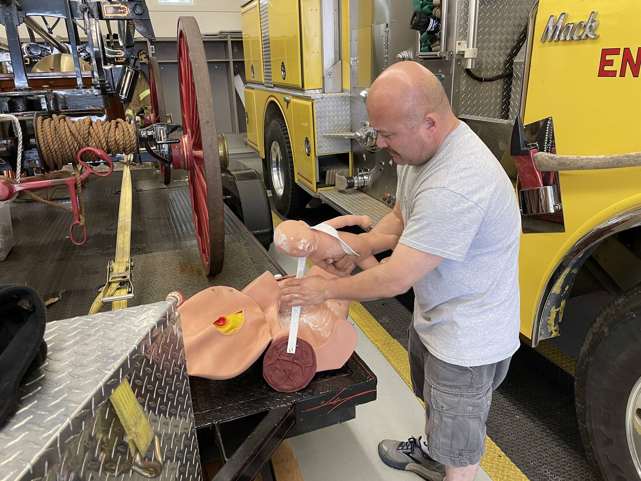 David Schrier, senior instructor for the county’s EMT academy readies the birth simulator mannequin for the next scenario during the EMT academy.