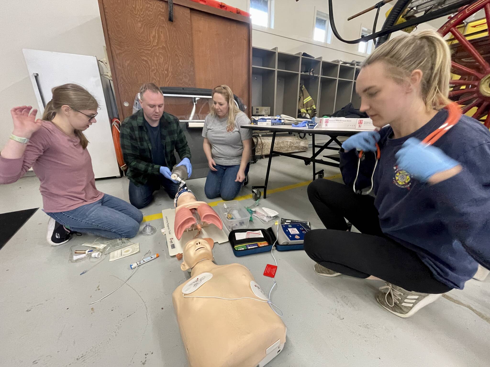 Volunteers work to provide lifesaving care during the EMT academy at the Cosmopolis Fire Department on April 22. Photo: Michael S. Lockett