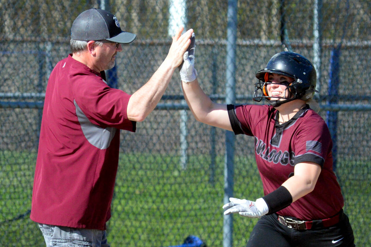 RYAN SPARKS | THE DAILY WORLD Montesano’s Alisyn Parkin gets a high-five from head coach Pat Pace after hitting a home run during the Bulldogs’ 12-6 victory over Elma on Thursday in Elma.