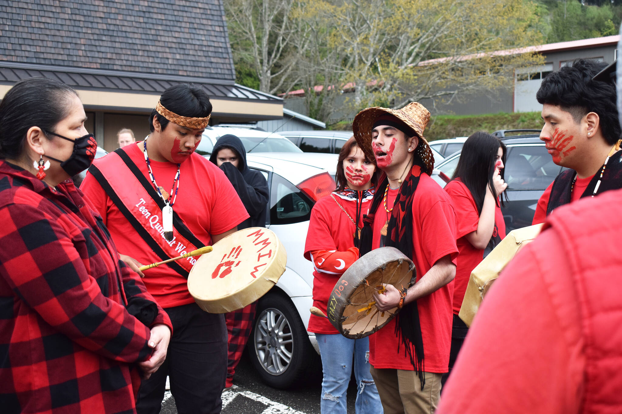 Matthew N. Wells / The Daily World
Right before the start of the Missing Murdered Indigenous Woman walk on Friday, Omar Ivan Estrada, second from left, Tyson Reece, center with drum and Anthony Watkins, helped lead the walk in a Mourning Prayer song. In addition to the three students mentioned, they couldn’t have done it without their female classmates, who Reece called “warriors.”
