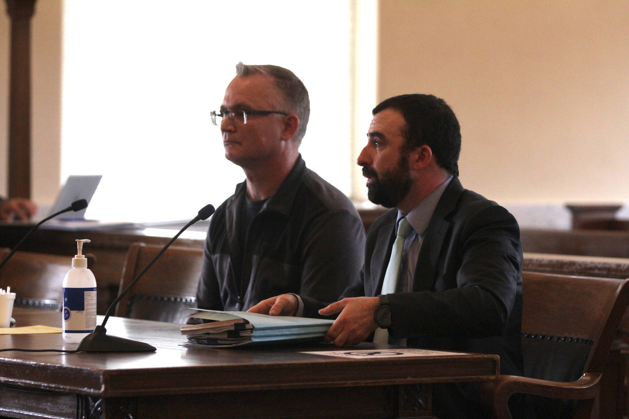 Wade Eric Iseminger, left, appears in his arraignment for multiple charges of child molestation, represented by Luke Laughlin, right, on May 8 in Grays Harbor County Superior Court. (Michael S. Lockett / The Daily World)