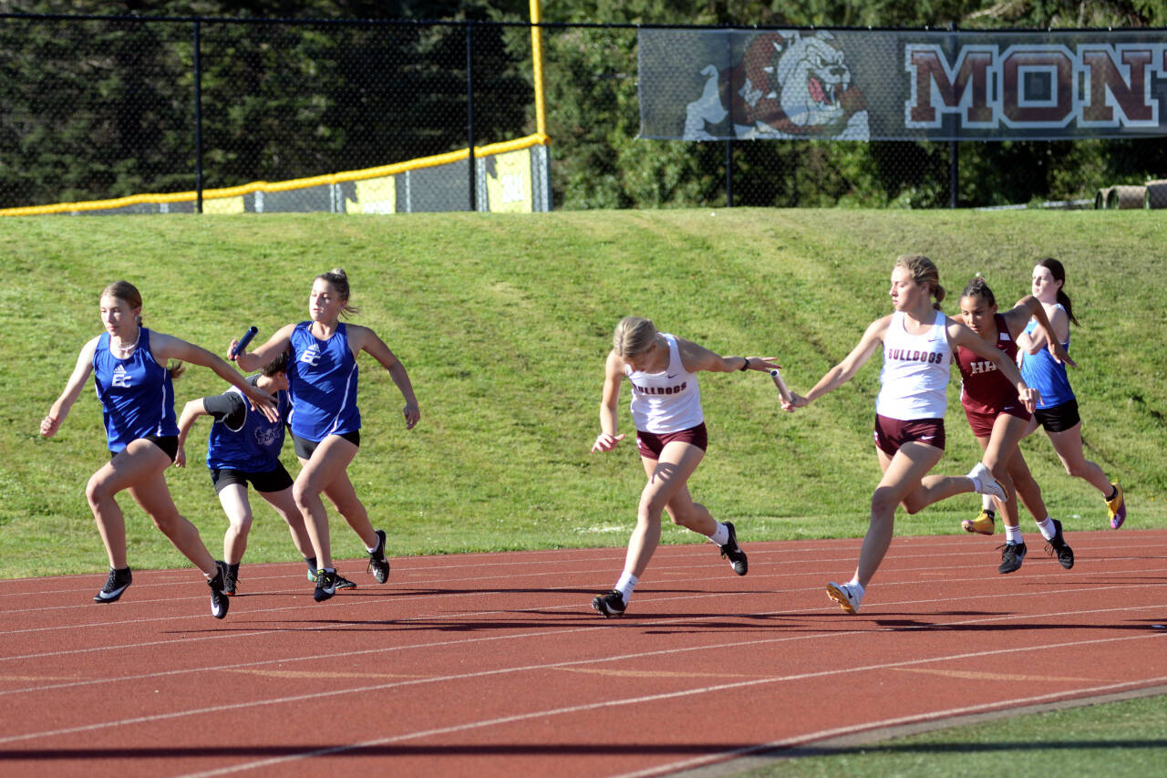 RYAN SPARKS | THE DAILY WORLD Montesano’s Lilly Causey, middle, takes the baton from Alayna Olson in the girls 4x100-meter relay race at the 1A Evergreen League Championships on Friday in Montesano.