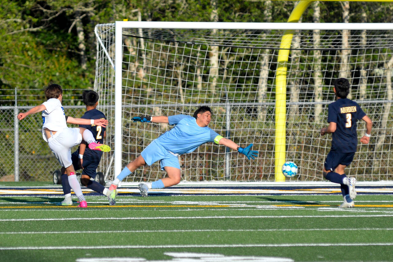 RYAN SPARKS / THE DAILY WORLD 
Aberdeen keeper Antonio Granados, middle, dives to attempt a save on a shot by Fife’s Lance Nelson, left, during the Bobcats’ 1-0 win in a 2A State Tournament game on Tuesday in Aberdeen.
