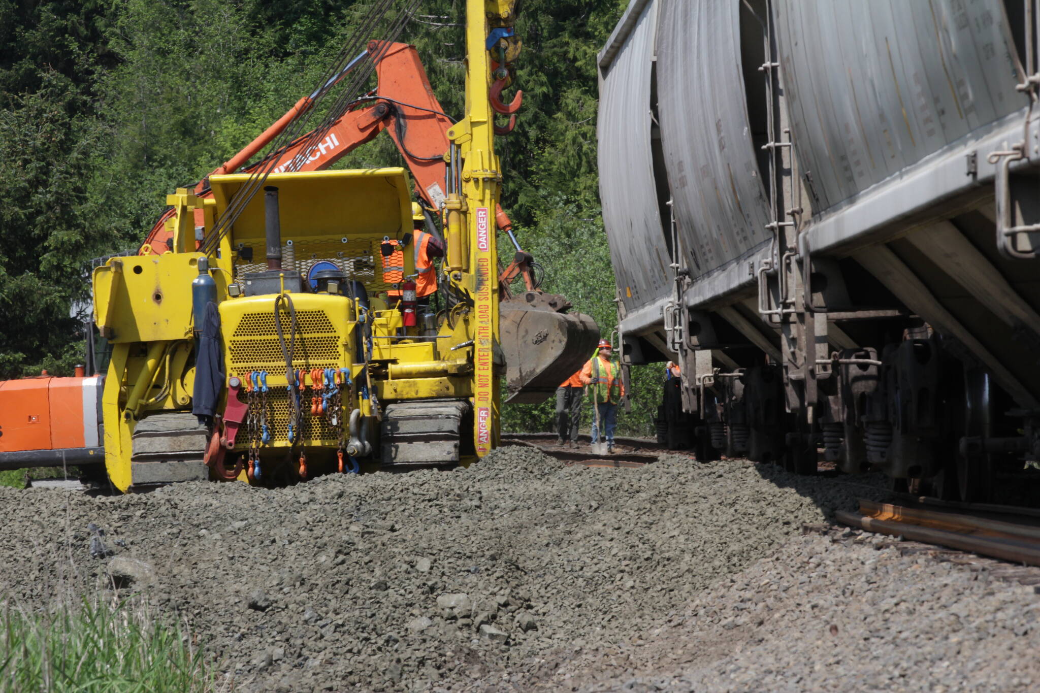 Michael S. Lockett / The Daily World
Crews work to rerail train cars carrying soymeal on May 17 on a Puget Sound & Pacific Railroad train that had eight cars derail Sunday in Central Park as a result of thermal misalignment, or heat expansion, of the tracks.