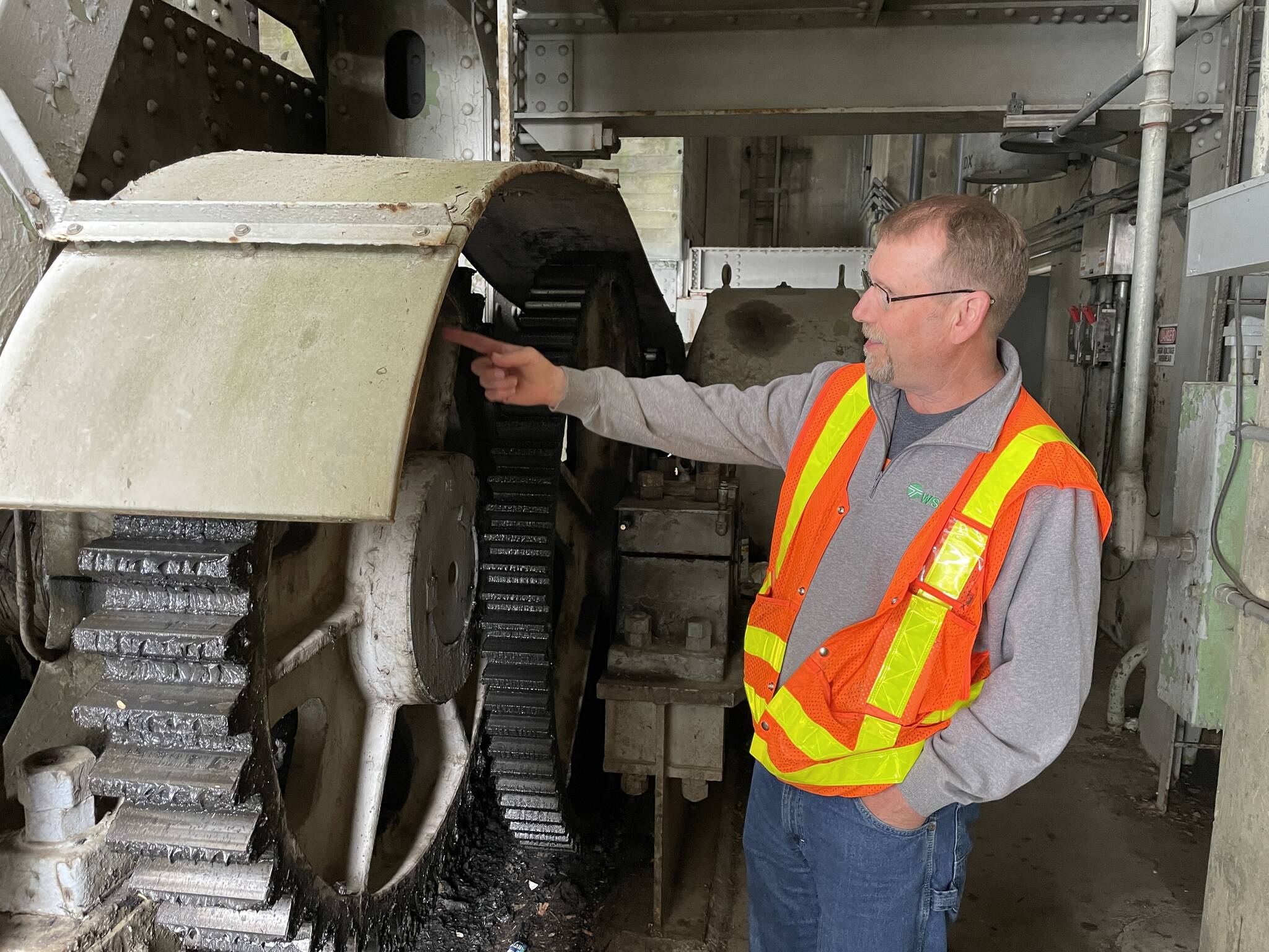 Michael S. Lockett / The Daily World
Dave Reibel, supervisor for the Washington Department of Transportation bridge maintenance team in the area, gestures at the mechanisms that operate the Chehalis River Bridge on May 16.