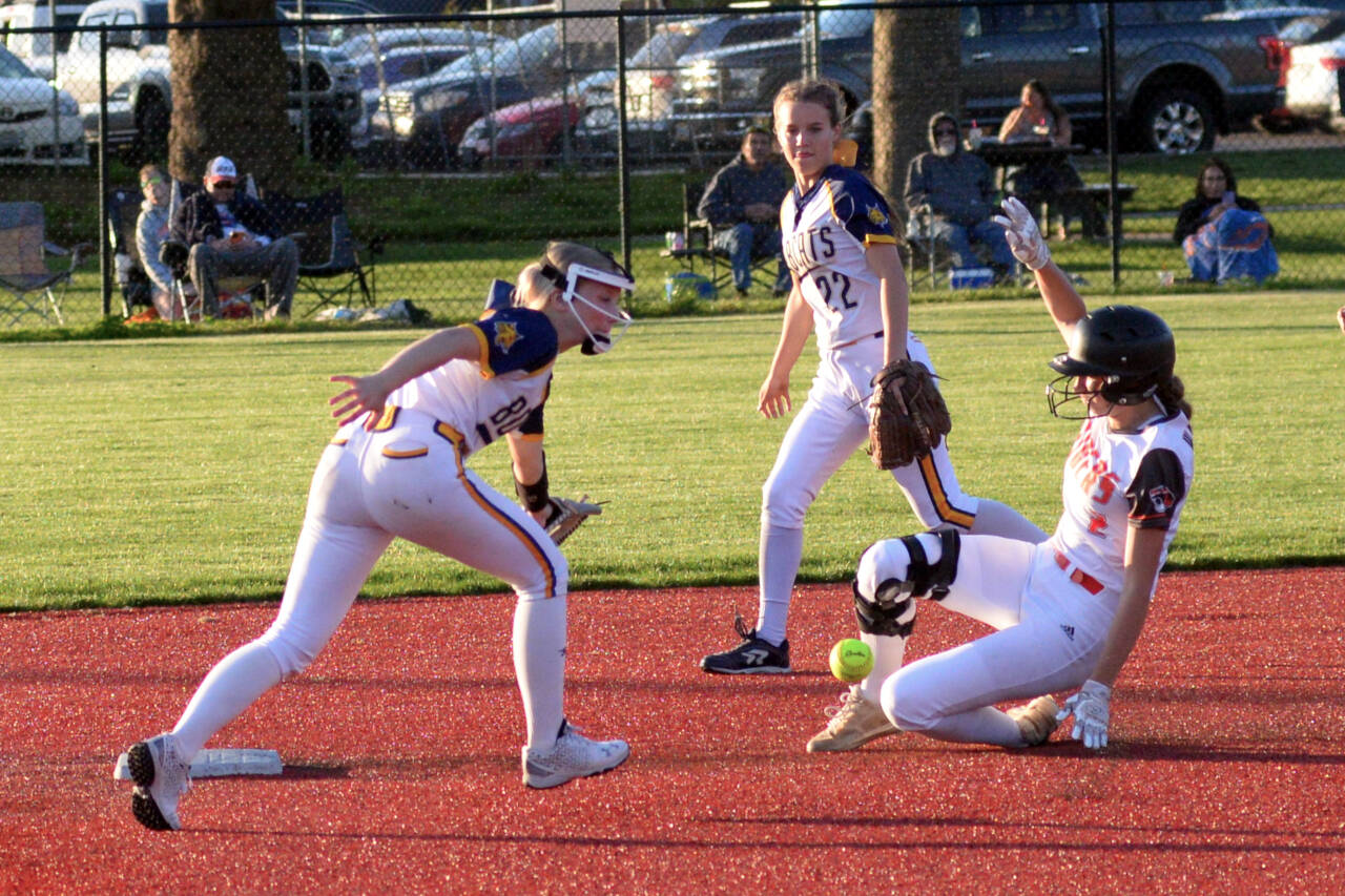 RYAN SPARKS | THE DAILY WORLD A throw to second gets past Aberdeen shortstop Zoe Vessey, left, and Aili Scott as Centralia’s Lauren Wasson slides in safely during the Bobcats 7-2 loss in a 2A District 4 semifinal game on Thursday in Chehalis.