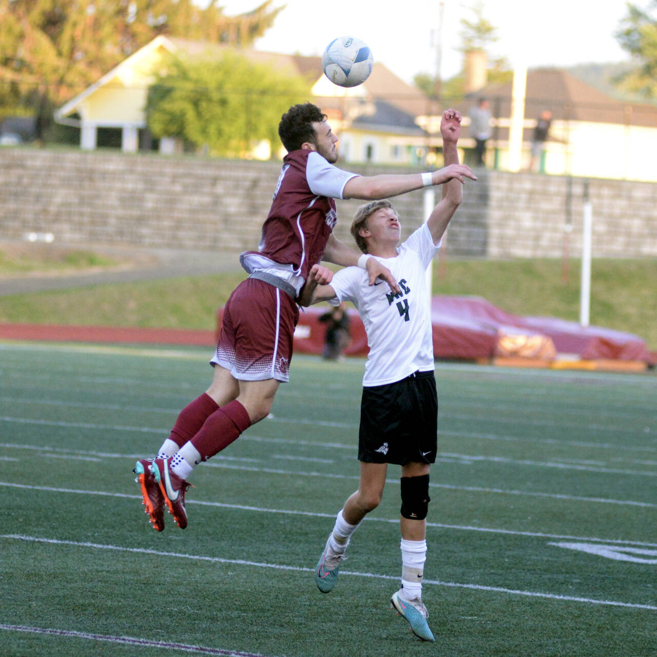 RYAN SPARKS | THE DAILY WORLD Montesano senior Mateo Sanchez, left, heads the ball against Northwest Christian’s Wesley Jones during the Bulldogs’ 1-0 victory in a 1A State Tournament game on Friday at Jack Rottle Field in Montesano.