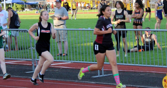 PHOTO BY AARON ANDERSON Ocosta’s Rebekah Stone, right, leads Raymond’s Genevieve Sarich during the 3200-meter race at the 2B District 4 Championships on Friday in Chehalis. Stone qualified for the state meet in three individual events.