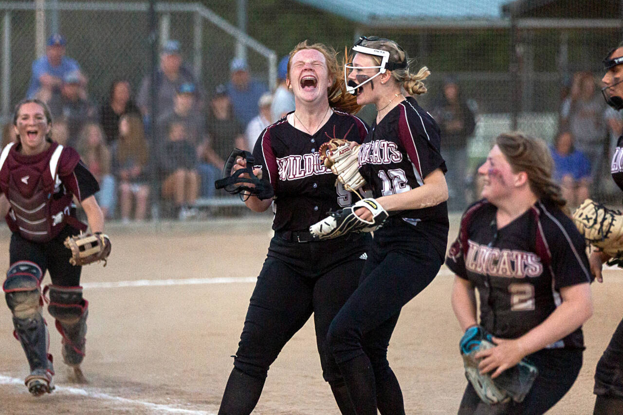 Ocosta’s Jessie Gilbert yells in celebration after helping the Wildcats win the 2B District 4 championship over Adna May 20 at Borst Park in Centralia.