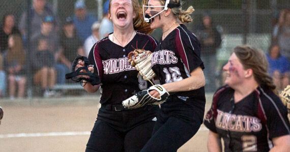 Ocosta's Jessie Gilbert yells in celebration after helping the Wildcats win the 2B District 4 championship over Adna May 20 at Borst Park in Centralia.