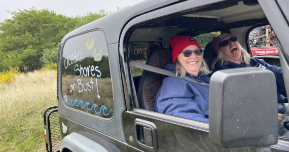 Clayton Franke / The Daily World
Penny Jackowski, left, and Kimber Lawrence, right, wait in the parking lot at Oyhut Bay in their 1999 Jeep, named “Little Foot,” on Saturday, May 20.