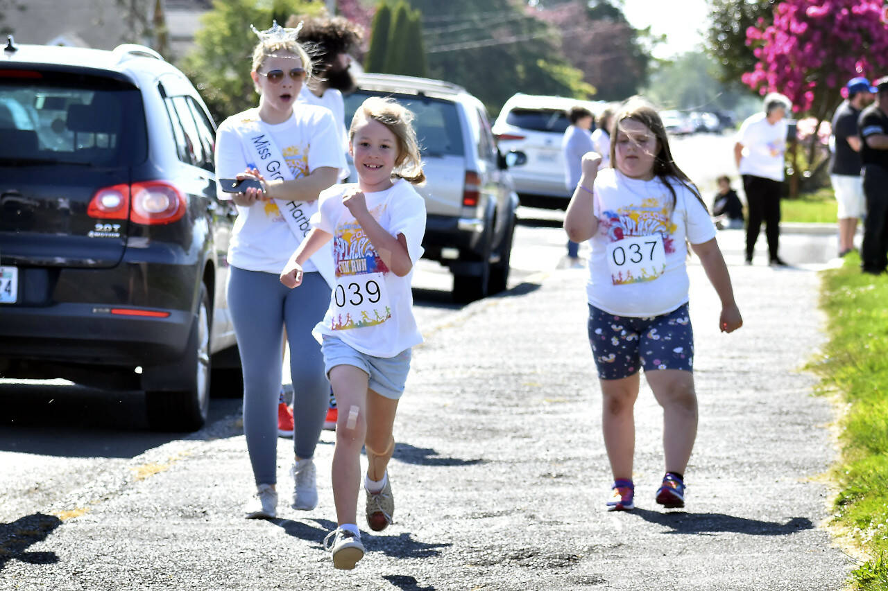 SUBMITTED PHOTO Miss Grays Harbor Lauren Fagerstedt, left, cheers on a runner during the Fun Run at AJ West Elementary School in Aberdeen on Friday.