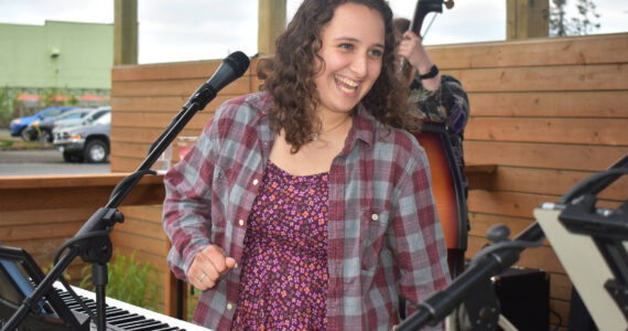 Matthew N. Wells / The Daily World
Amanda Ransom, who sings and plays the keyboard with her Saturday night bandmates on May 20, smiles during a lively and fun performance at Mount Olympus Brewing. Ransom said playing the piano is in her blood.