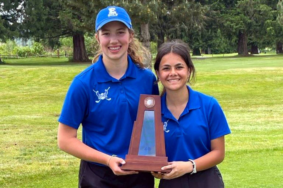 SUBMITTED PHOTO Elma’s Olivia Moore, left, and Sophia Hamilton pose with their state trophy after scored a total of 32 points to place third in the team standings at the 1A State Tournament on Wednesday in Chehalis.