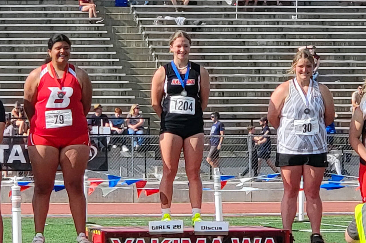 SUBMITTED PHOTO Raymond sophomore Karsyn Freeman, middle, stands atop the podium after winning the 2B girls discus state championship on Friday in Yakima.