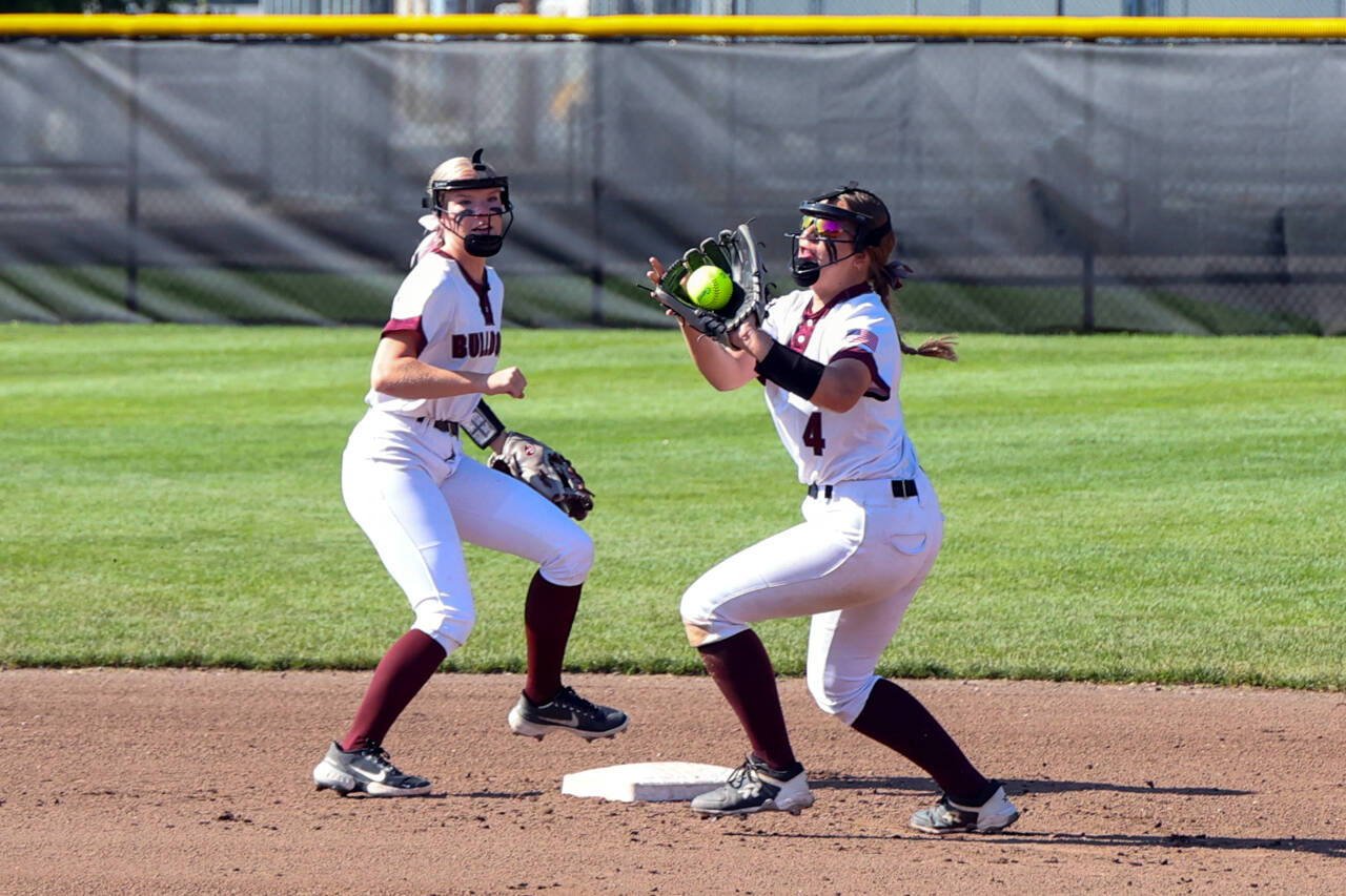 PHOTO BY SHAWN DONNELLY 
Montesano second baseman Jordan Karr, right, makes a play while shortstop Addi Kersker looks on during the Bulldogs’ 8-2 win over Royal in the 1A State Softball Championship game on Sunday in Richland.