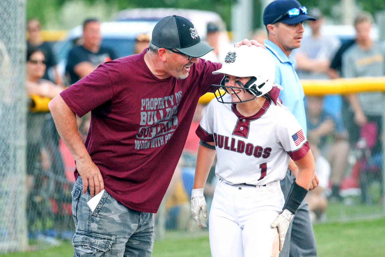 PHOTO BY SHAWN DONNELLY 
Montesano head coach Pat Pace shares a laugh with sophomore Addi Kersker during the Bulldogs’ 8-2 win over Royal in the 1A State Softball Championship game on Sunday in Richland. Pace won his 11th state title as coach of the Bulldogs.