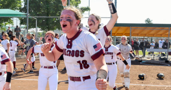 PHOTO BY SHAWN DONNELLY Montesano’s Kylee Wisdom (18), Carsyn Wintrip (left) and Allison Mills (background) celebrate winning the 1A State Softball Championship after an 8-2 victory over Royal on Sunday in Richland.