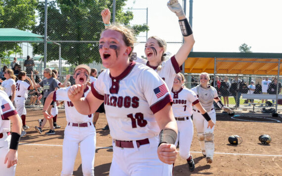 PHOTO BY SHAWN DONNELLY Montesano’s Kylee Wisdom (18), Carsyn Wintrip (left) and Allison Mills (background) celebrate winning the 1A State Softball Championship after an 8-2 victory over Royal on Sunday in Richland.