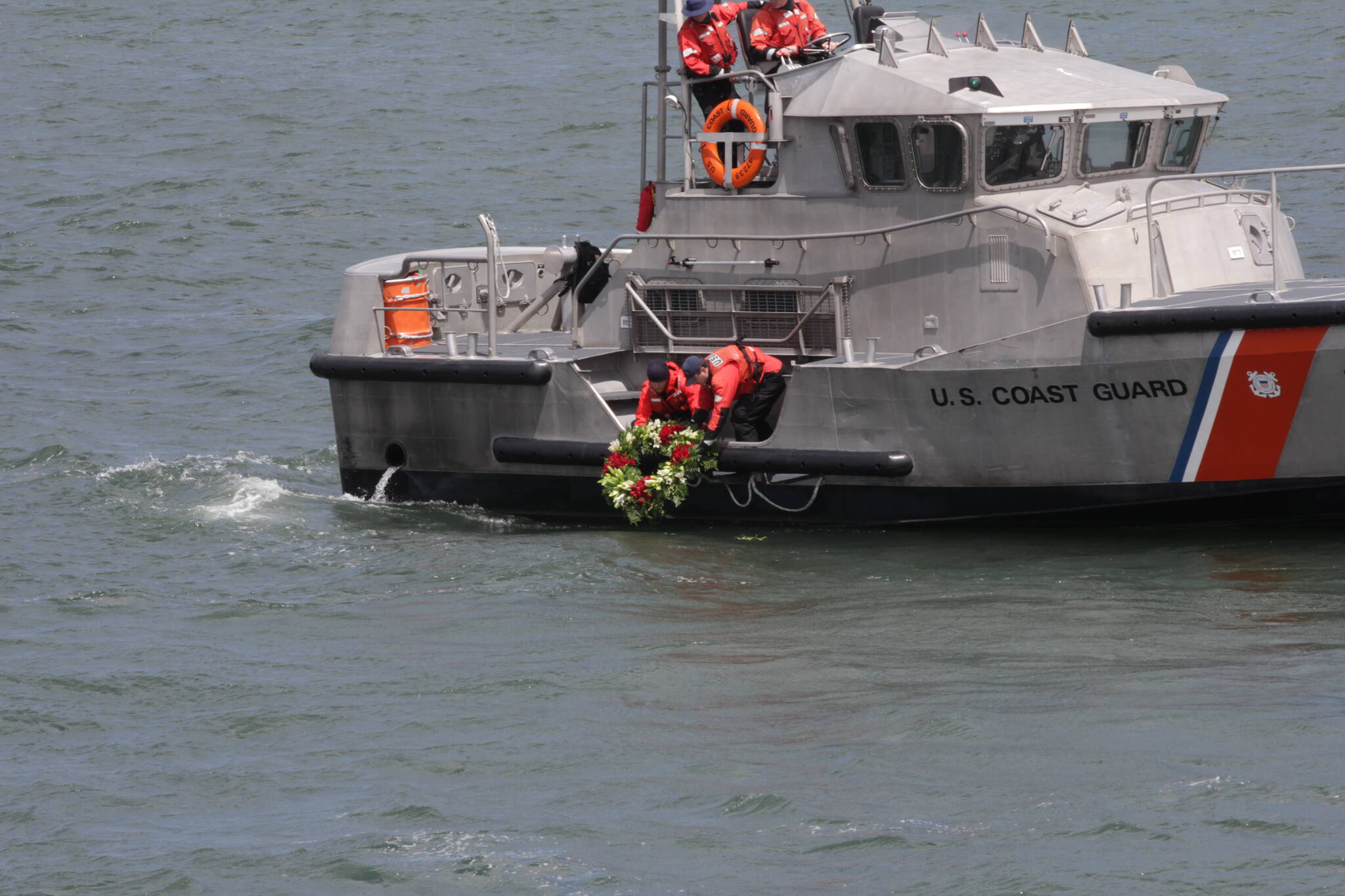 A boat crew from Coast Guard Station Grays Harbor lower the traditional wreath into the ocean during the Blessing of the Fleet on May 28 in Westport. (Michael S. Lockett / The Daily World)