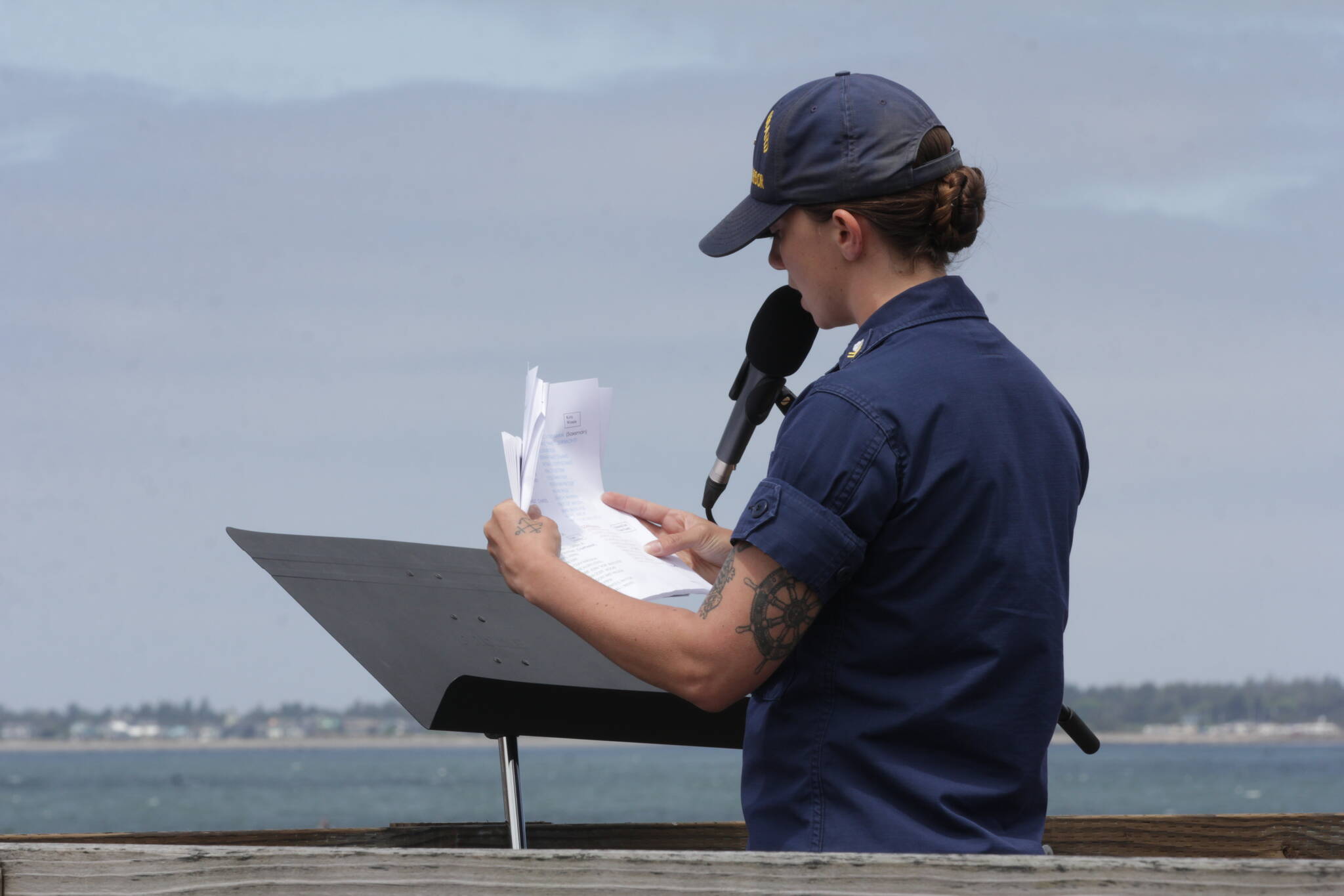 Petty Officer 2nd Class Victoria True, of Coast Guard Station Grays Harbor, reads of the names of Coast Guardsmen who went to sea and did not return during a ceremony on May 28. (Michael S. Lockett / The Daily World)