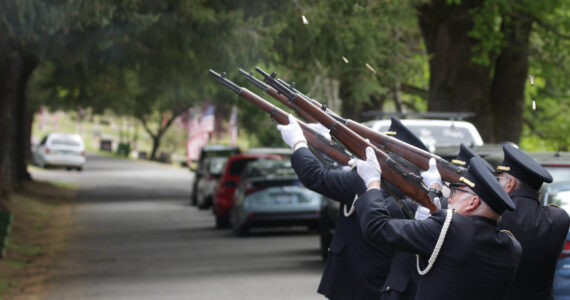 The Veterans of Foreign Wars Post 224 honor guard fires the third volley of a rifle salute during a Memorial Day Ceremony at Fern Hill Cemetery on May 29. (Michael S. Lockett / The Daily World)