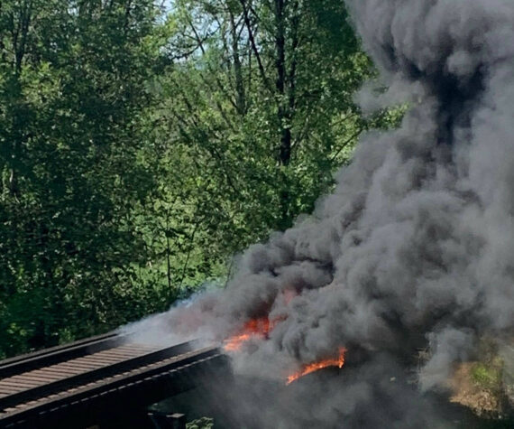 A fire burns on a Puget Sound & Pacific Railroad trestle bridge south of Elma on June 3. (Courtesy photo / Grays Harbor County Sheriff’s Office)