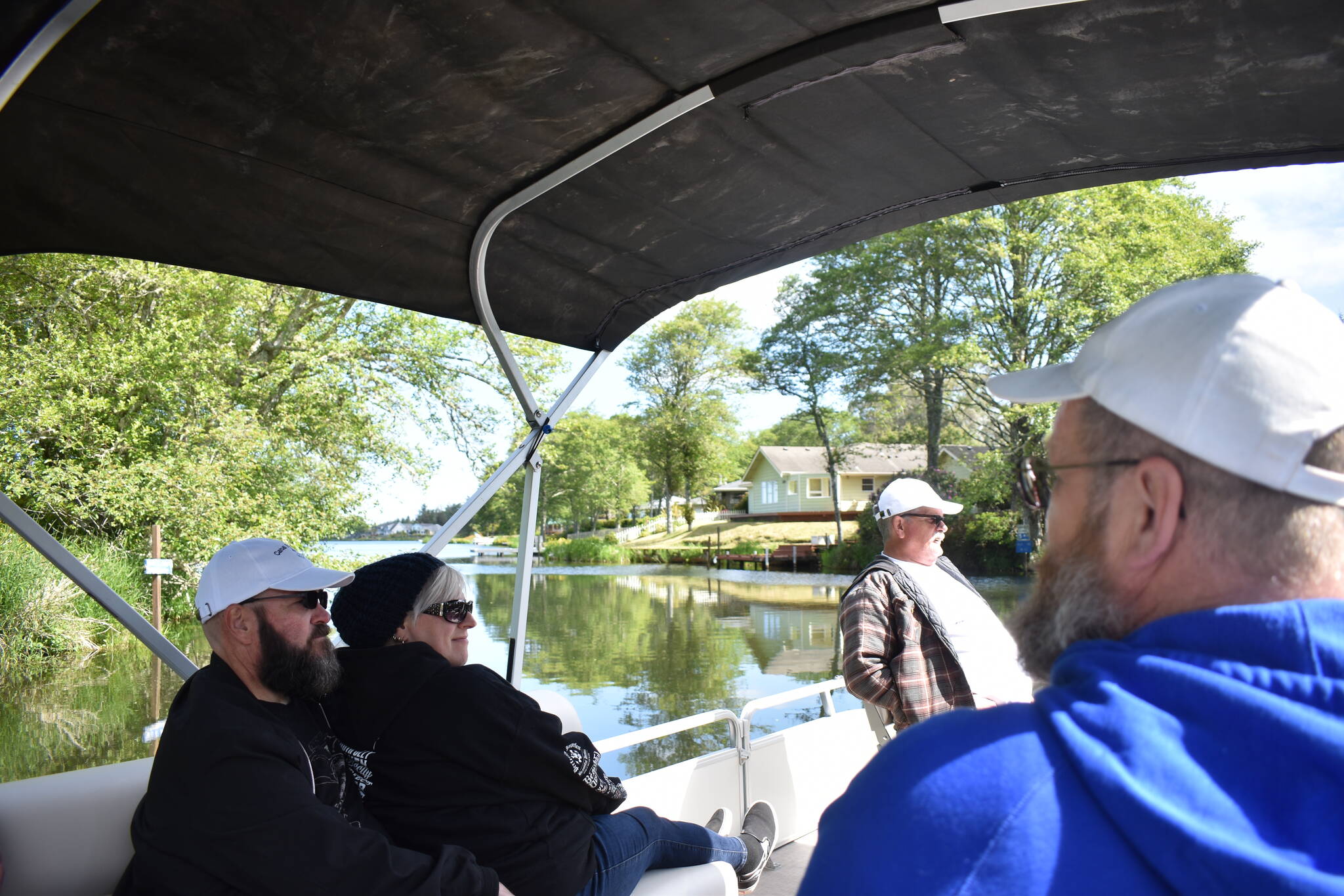 From left: Bob LaBorde, Alicia Roman and Dale Vacknitz accompany Jeff Owen on a tour of the Ocean Shores canal system on Friday, June 2. LaBorde and Owen founded Canal Brothers of Ocean Shores eight years ago, and LaBorde now lives in California.