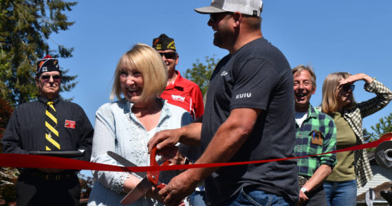 Matthew N. Wells / The Daily World
Linda Springer and Jeff Nations, Cosmopolis’ parks superintendent, cut the red ribbon in a ceremony that welcomed about 60 people to Highland Park. The park has gone through a slew of renovations, including countless hours from community volunteers.